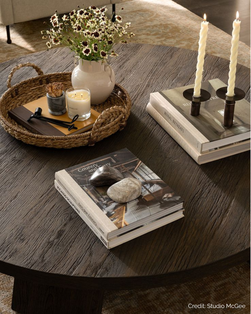 Luxury interior decor styling with books, candles, and natural textures