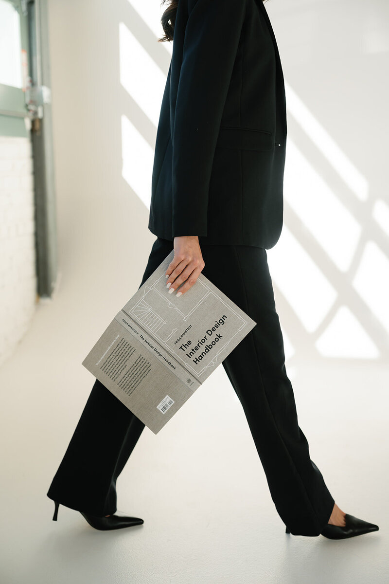 Interior designer walking through studio with design plans